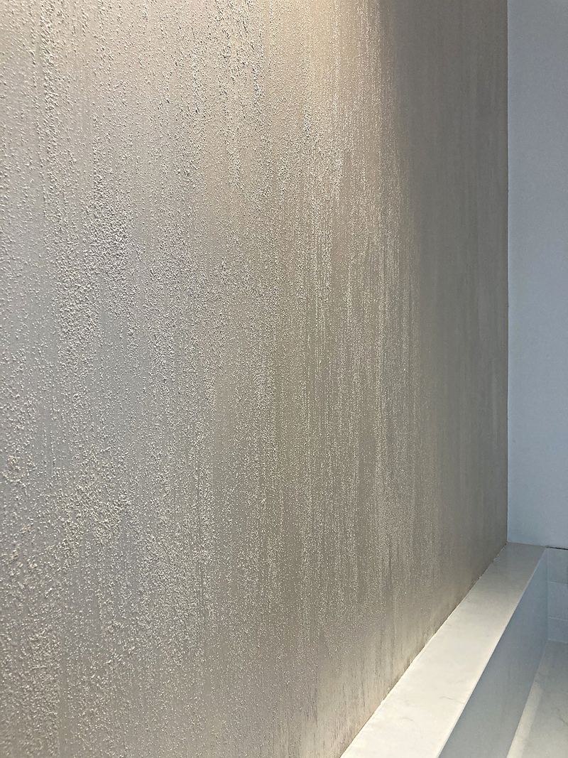 Close-up of Ed's hand-trowelled plaster, showing its layered, shimmering texture